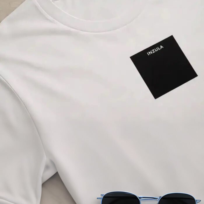 Close-up of INZULA washed gray foundation tee showing black square logo and fabric detail